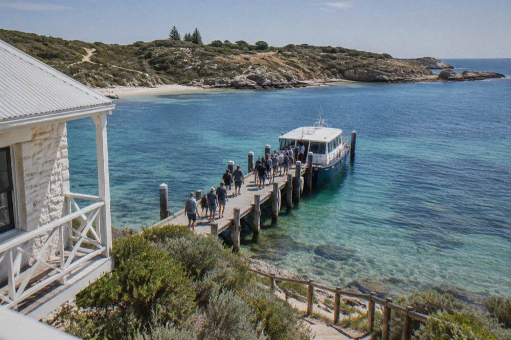 Calm turquoise water at the Rottnest Island ferry jetty with passengers waiting to board