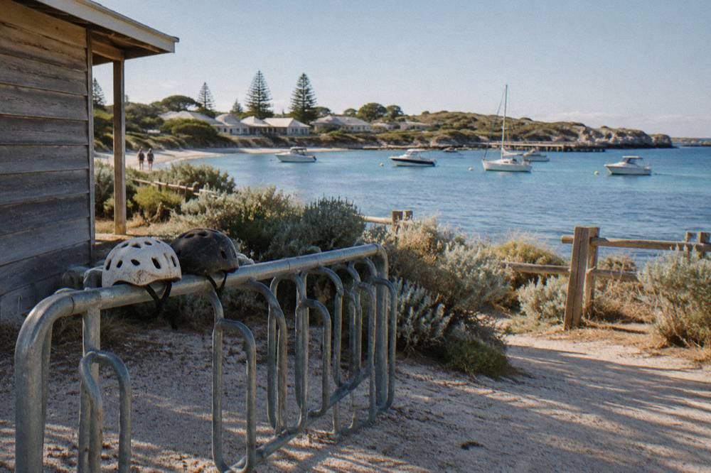 Bicycles leaning on a rack near the Thomson Bay settlement with the sea behind