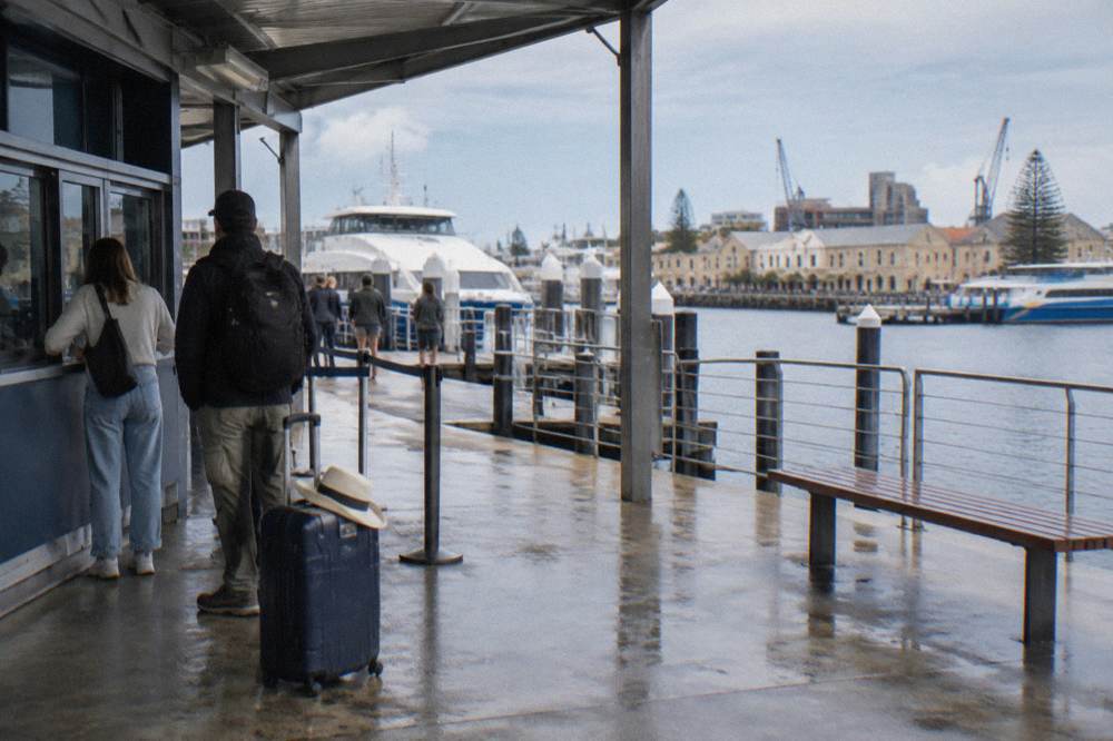 A ferry ticket office and boarding queue at a Fremantle jetty terminal