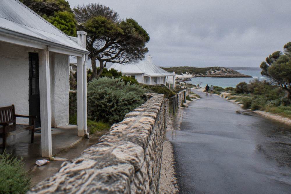 Bicycles parked near heritage stone buildings in the Thomson Bay settlement