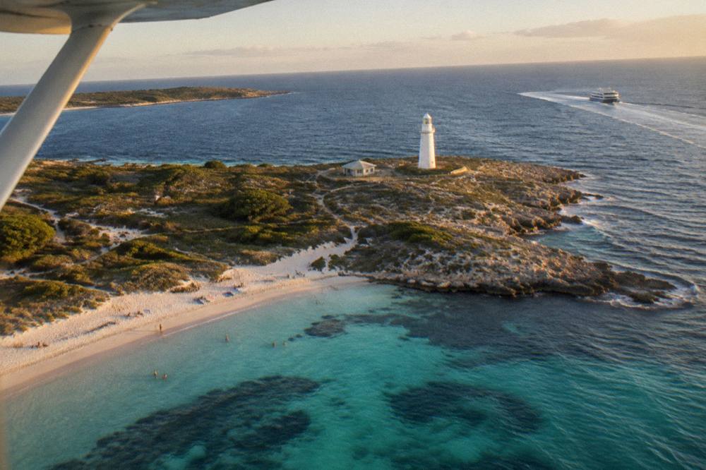 A ferry approaching the Rottnest Island coastline in late afternoon light