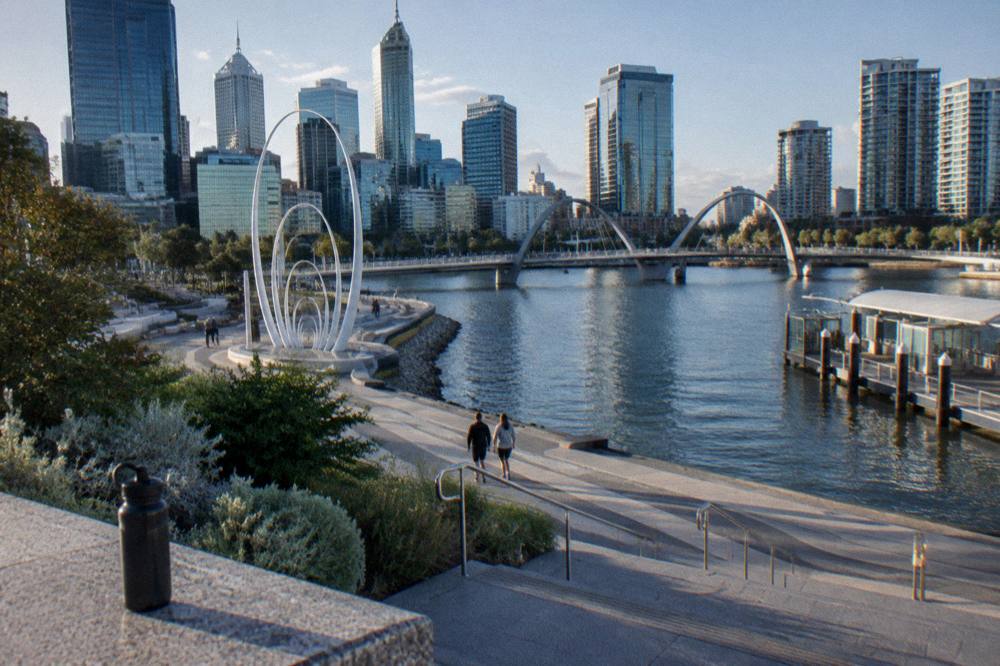 The Elizabeth Quay waterfront in Perth city with modern buildings and a sculpture beside the river