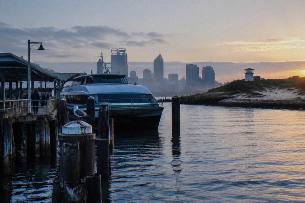 A city jetty on the Swan River with a ferry moored at sunrise