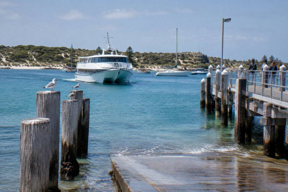 Ferry approaching the main jetty at Thomson Bay with moored boats
