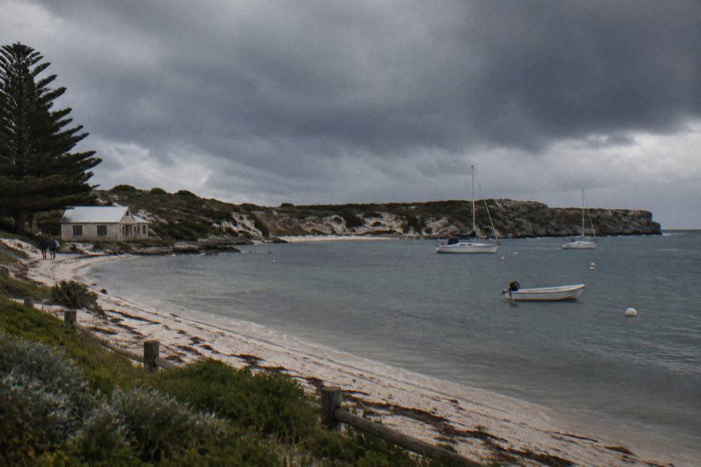 Wind ruffling the surface of a sheltered bay with dark clouds above