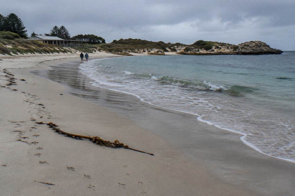 A quiet sandy beach on Rottnest Island with gentle waves and winter morning light