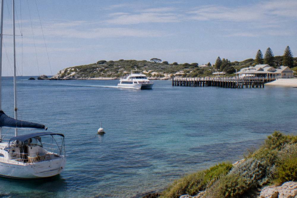 A ferry approaching the Rottnest Island main jetty across calm blue water